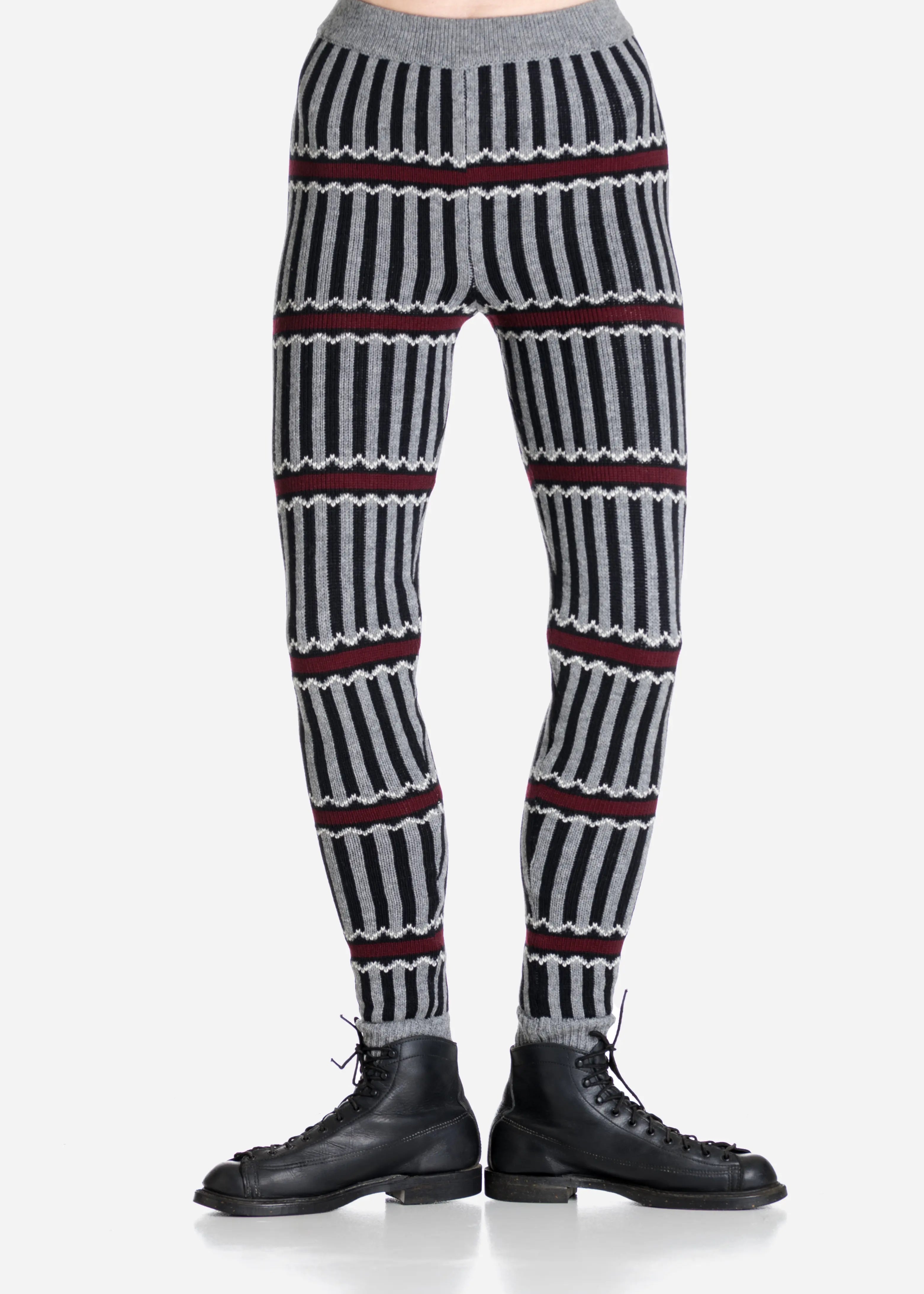 Striped patterned pants worn by a person on a light gray background