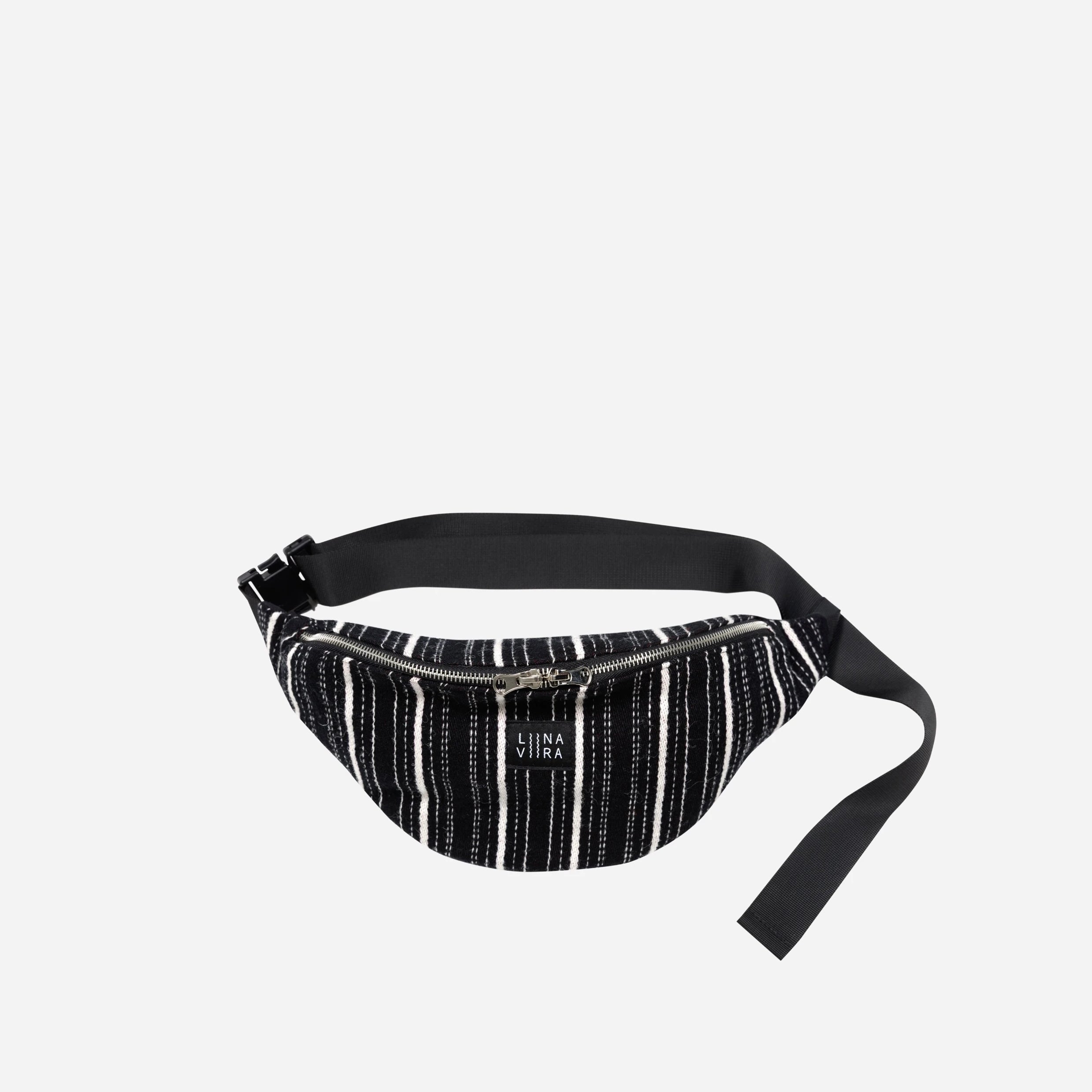 Black and white striped waist bag on a light gray background