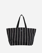 Black and white striped tote bag on a light gray background