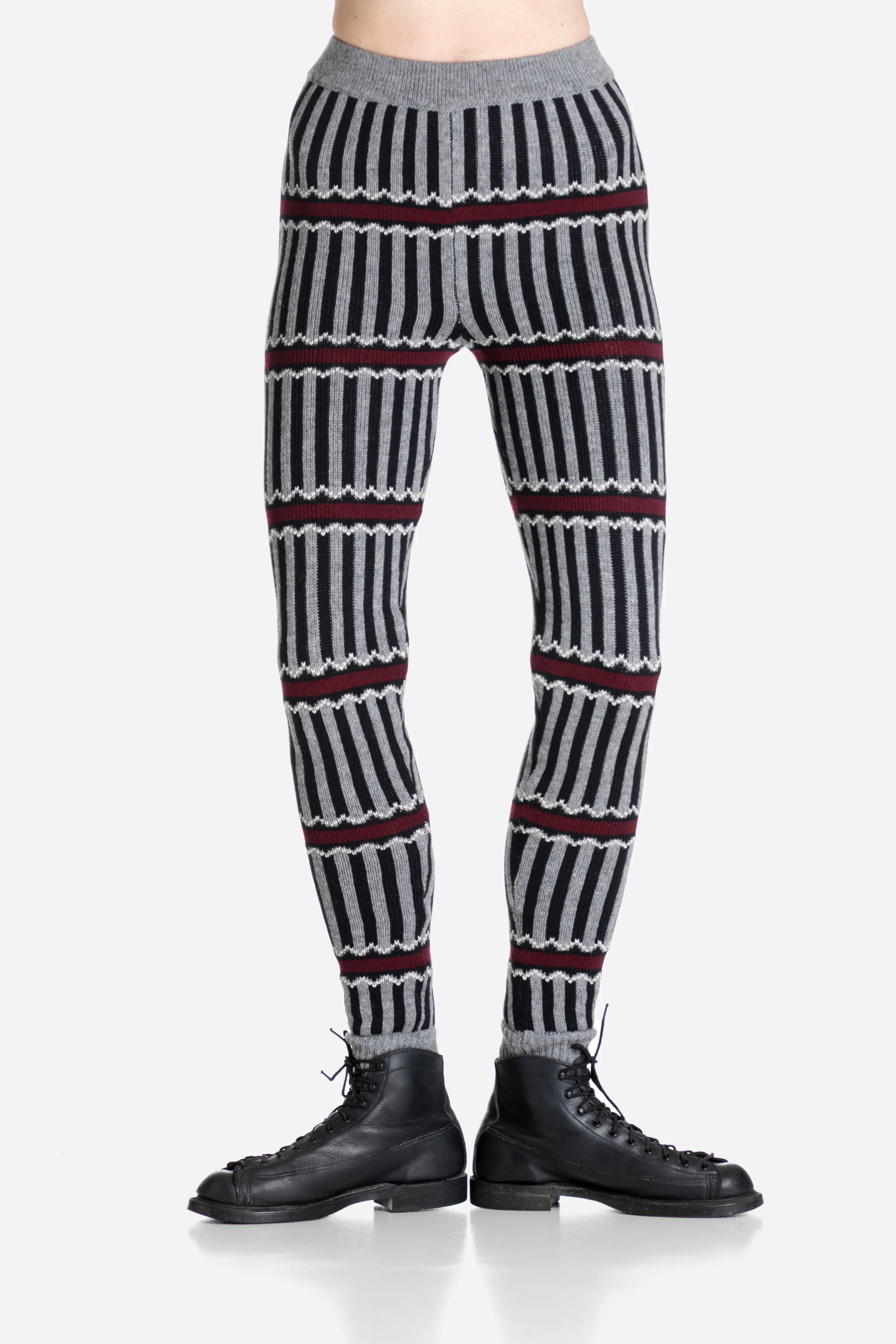 Striped patterned pants worn by a person on a light gray background